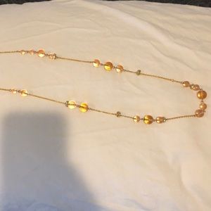 Long gold necklace with pink and crystal beads